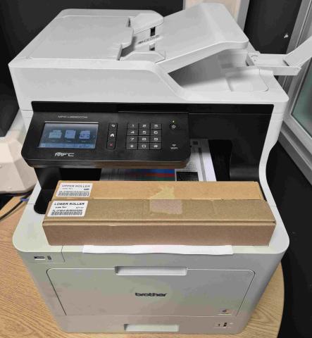 A Brother MFC-L8690CDW color laser printer operating in a West Yorkshire office.